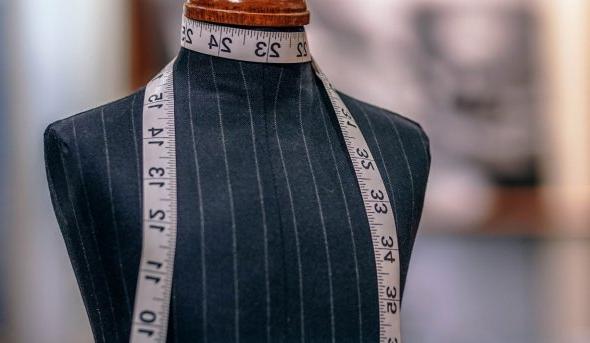 Fashion mannequin with measuring tape around neck 